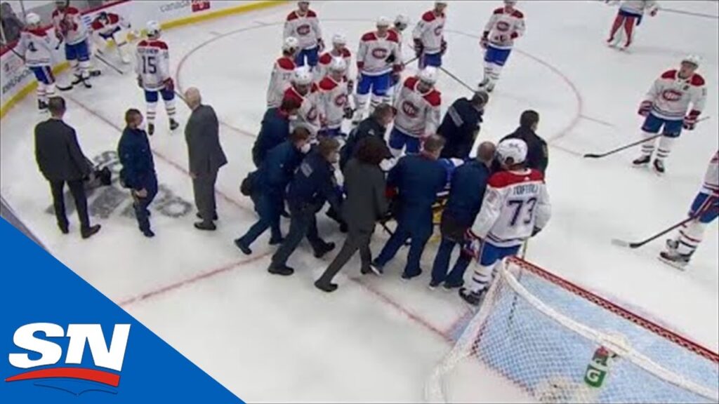 jake evans stretchered off ice after huge hit from mark scheifele following empty net goal