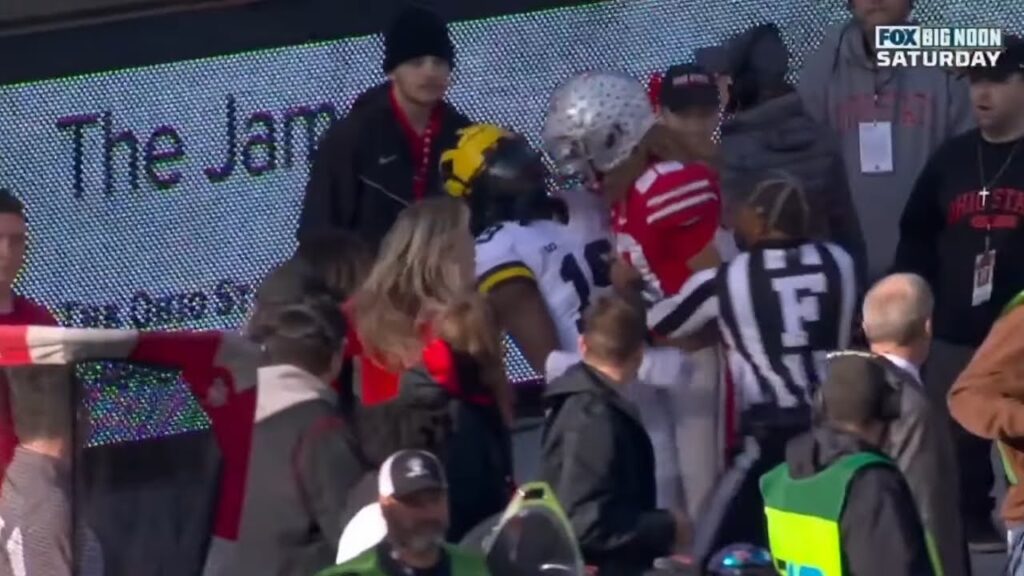 ohio state player gets penalized for headbutting michigan player out of bounds